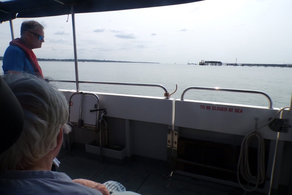 Passengers enjoying scenic sea views from a boat.