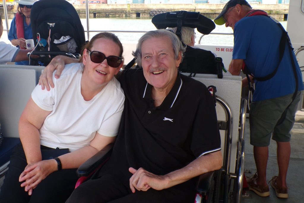 Elderly man and woman enjoying a boat trip together.
